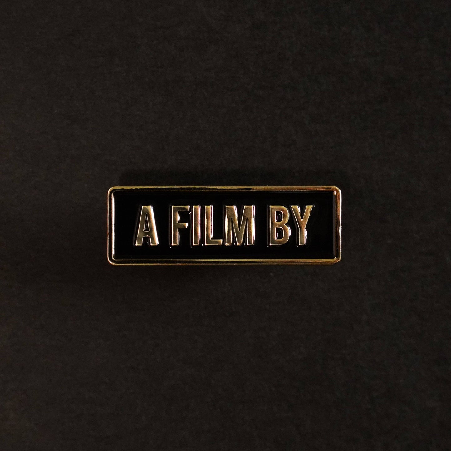 A Film by Credit Enamel Pin